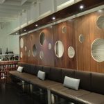 Brown leather sofa with decorative wood backdrop.