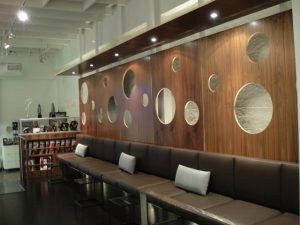 Brown leather sofa with decorative wood backdrop.